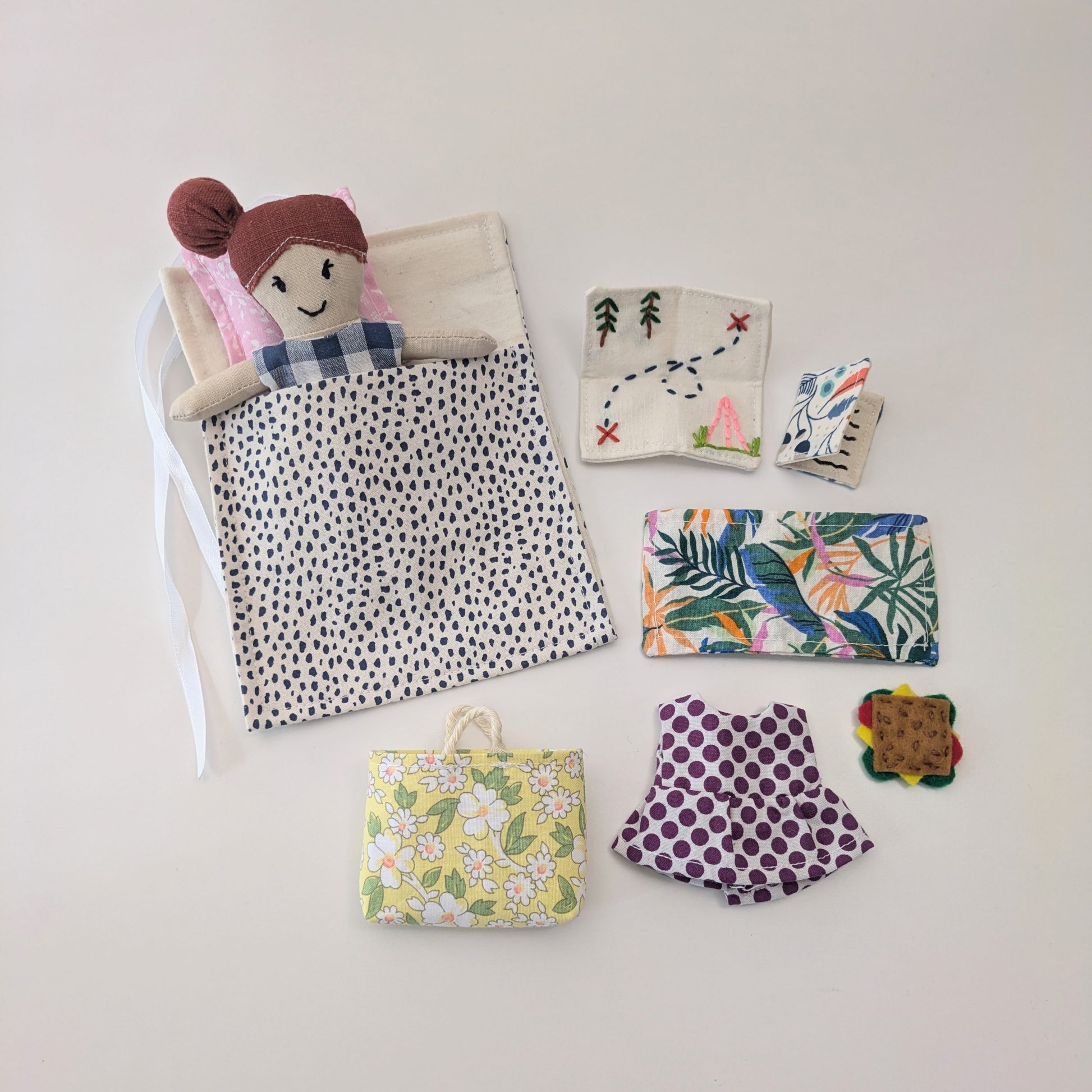 Detailed shot of the Adventure Book sewing project with layered fabrics and embroidery.