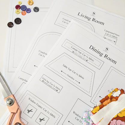 Fabric layout planning sheet for living room and dining room with scissors and fabric samples.