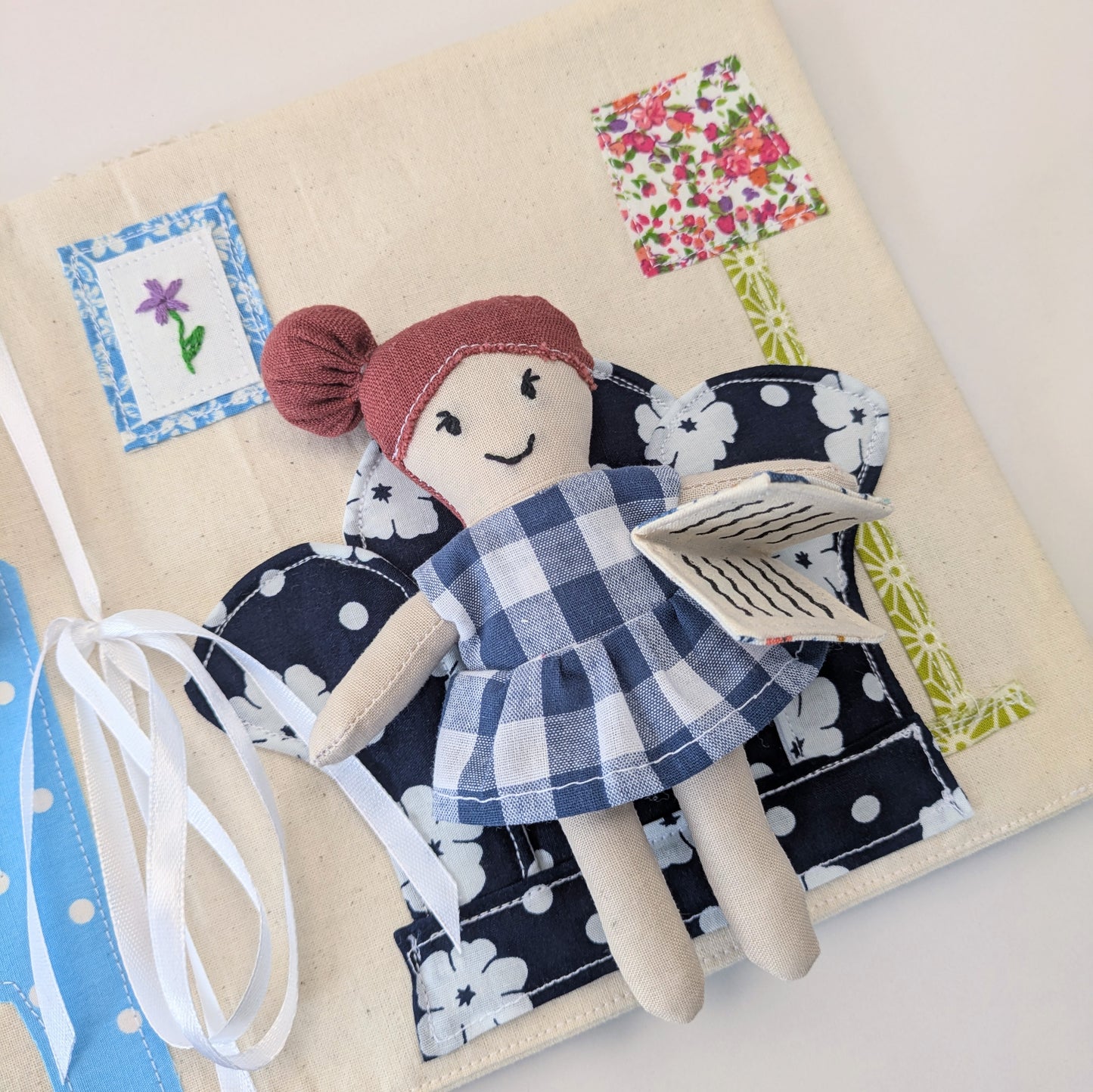 Detailed interior view of the fold-up fabric dollhouse with layered appliqué.