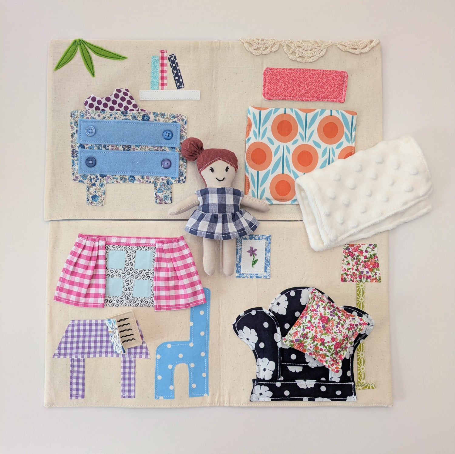 Fabric dollhouse opened fully to show all interior rooms and stitched details.