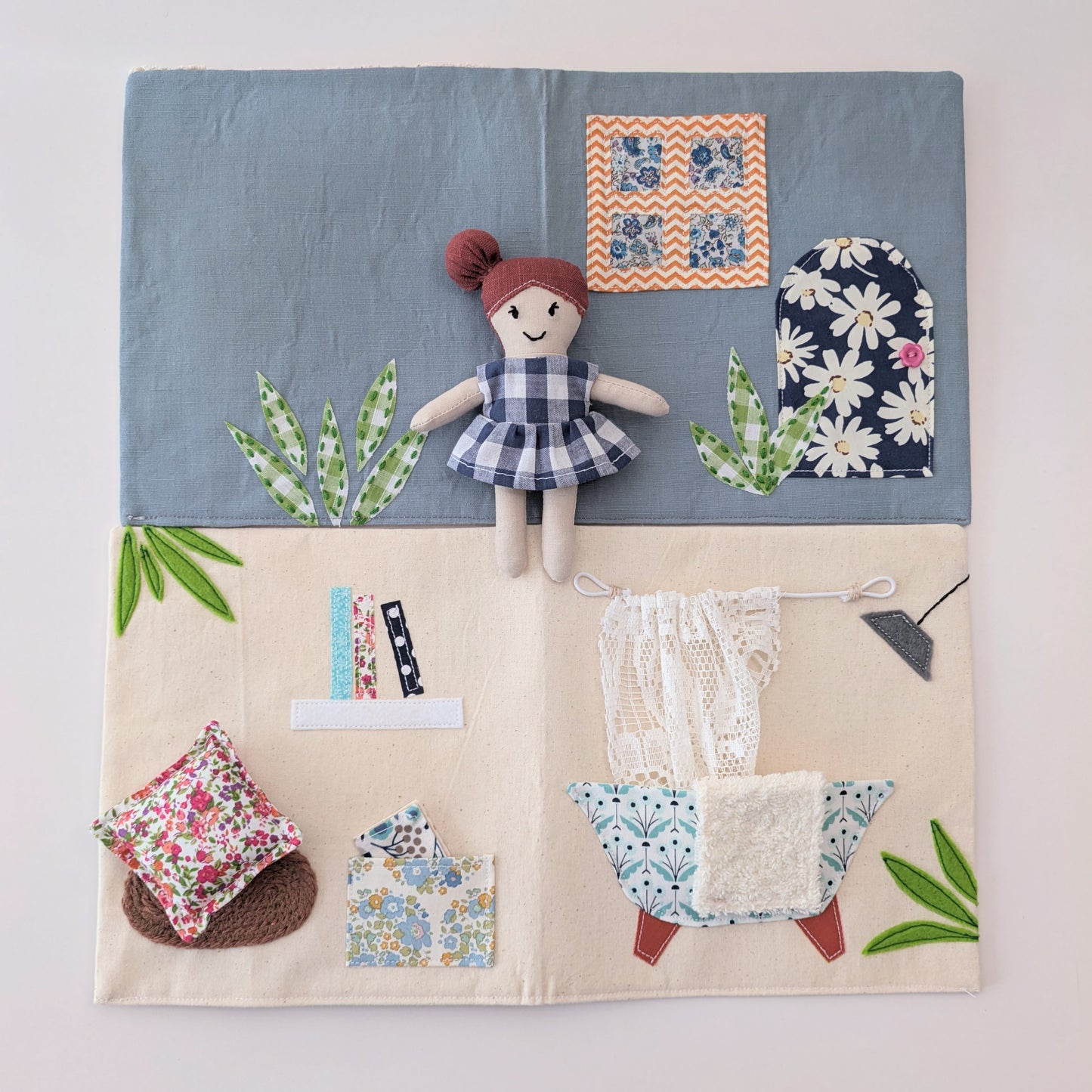 Dollhouse opened to display the outer cover design and fabric construction.